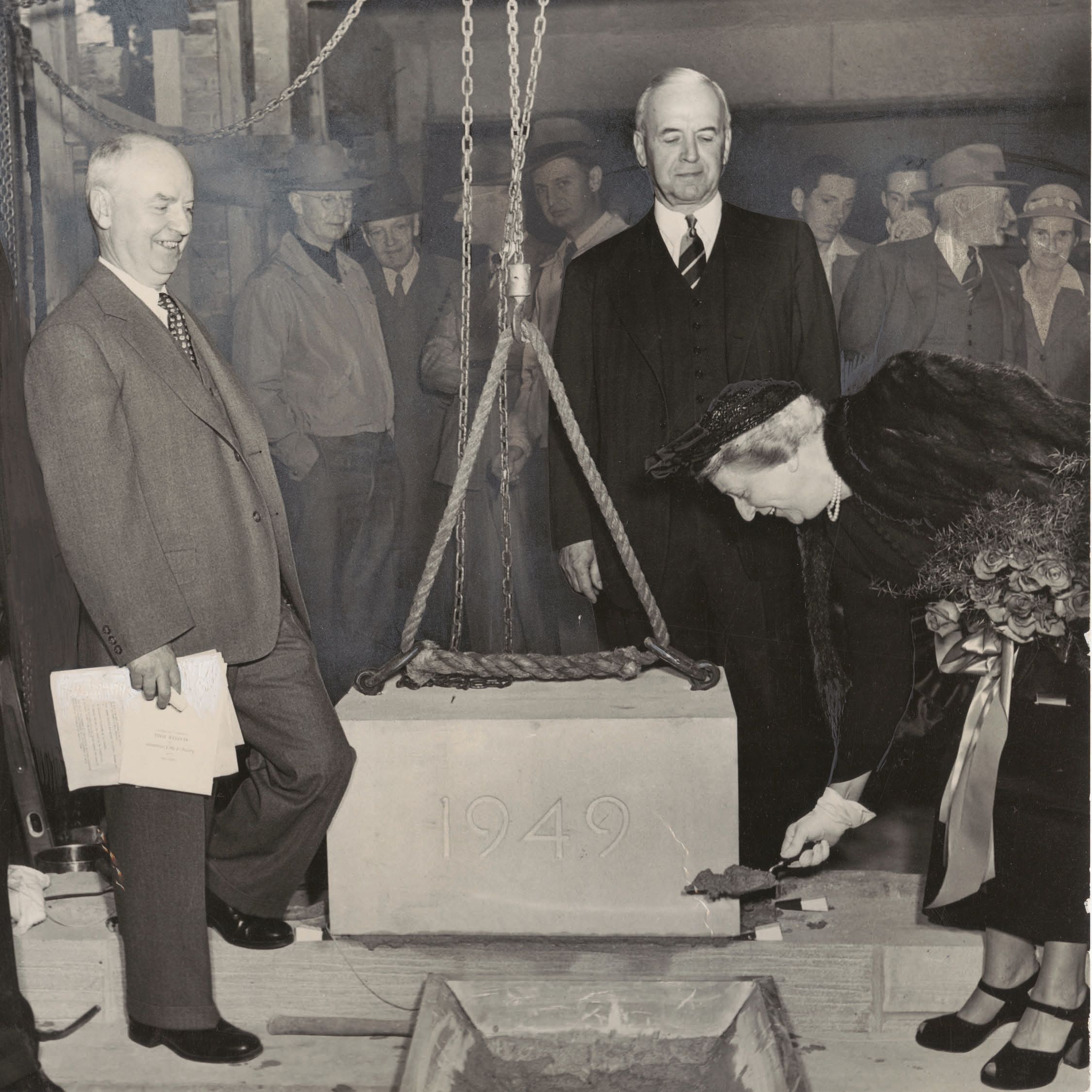 Alice Statler holds a shovel of dirt.