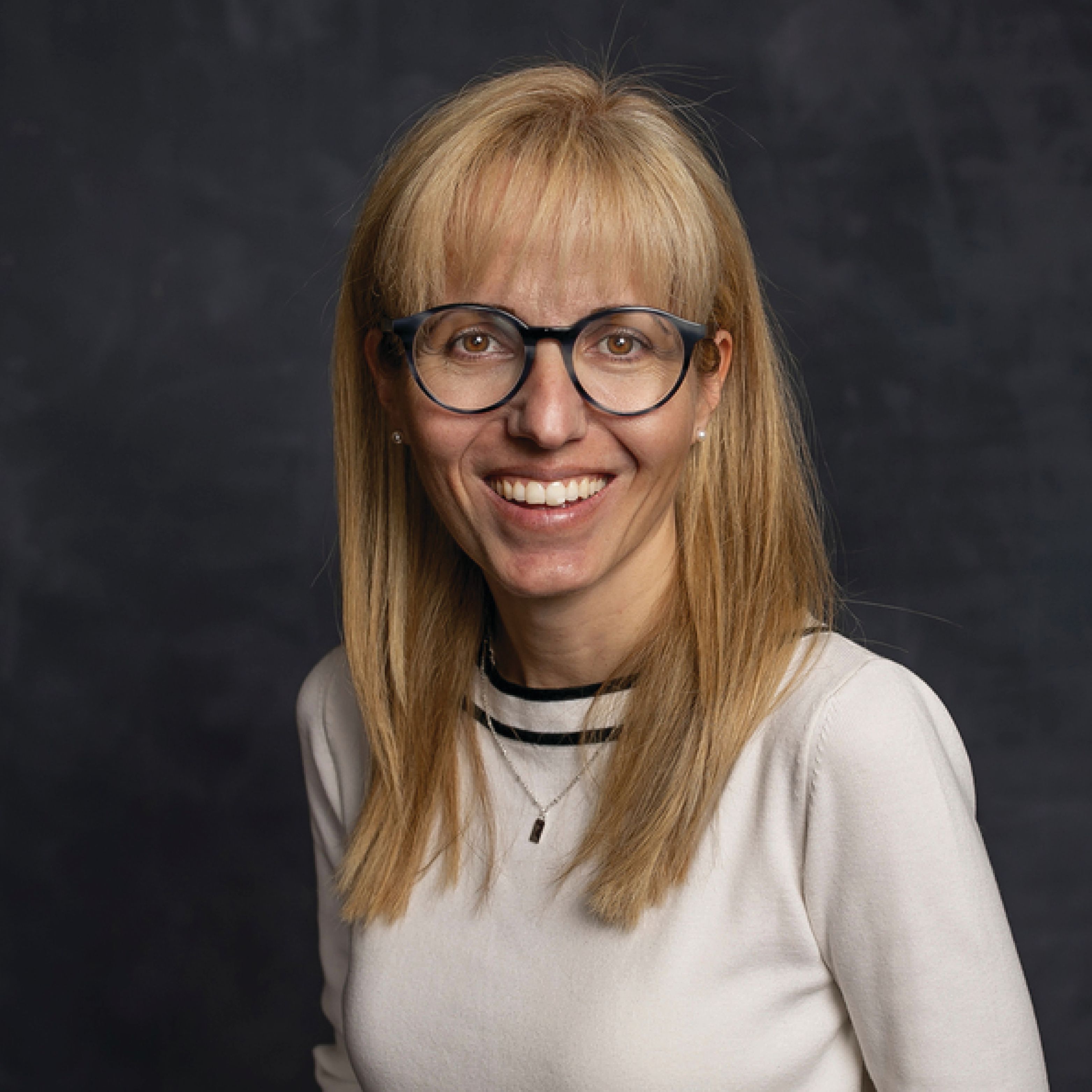 Headshot of Dragana Cvijanović smiling in a white top.