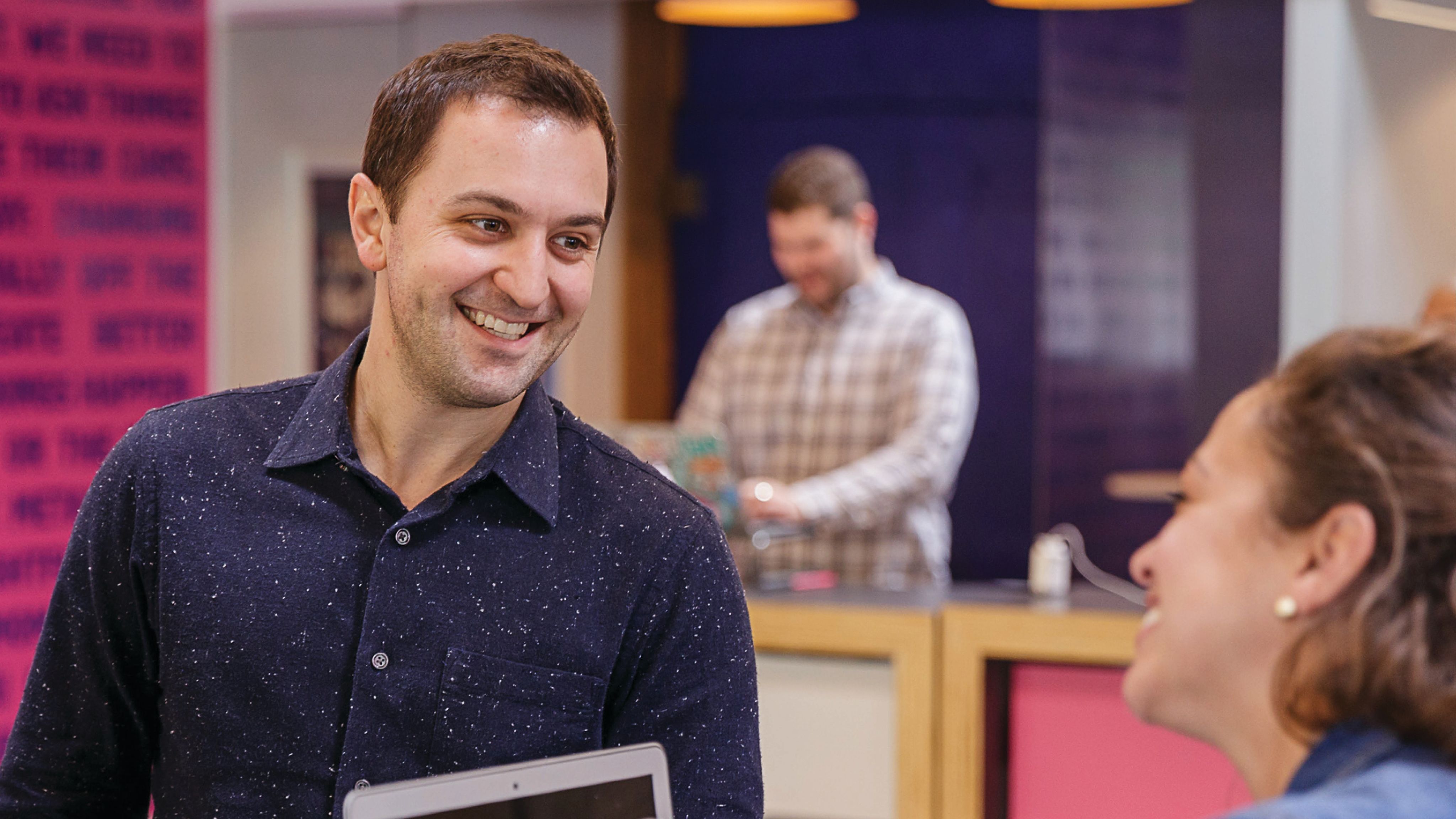 John Zimmer ’06 smiles walking around the Lyft office.