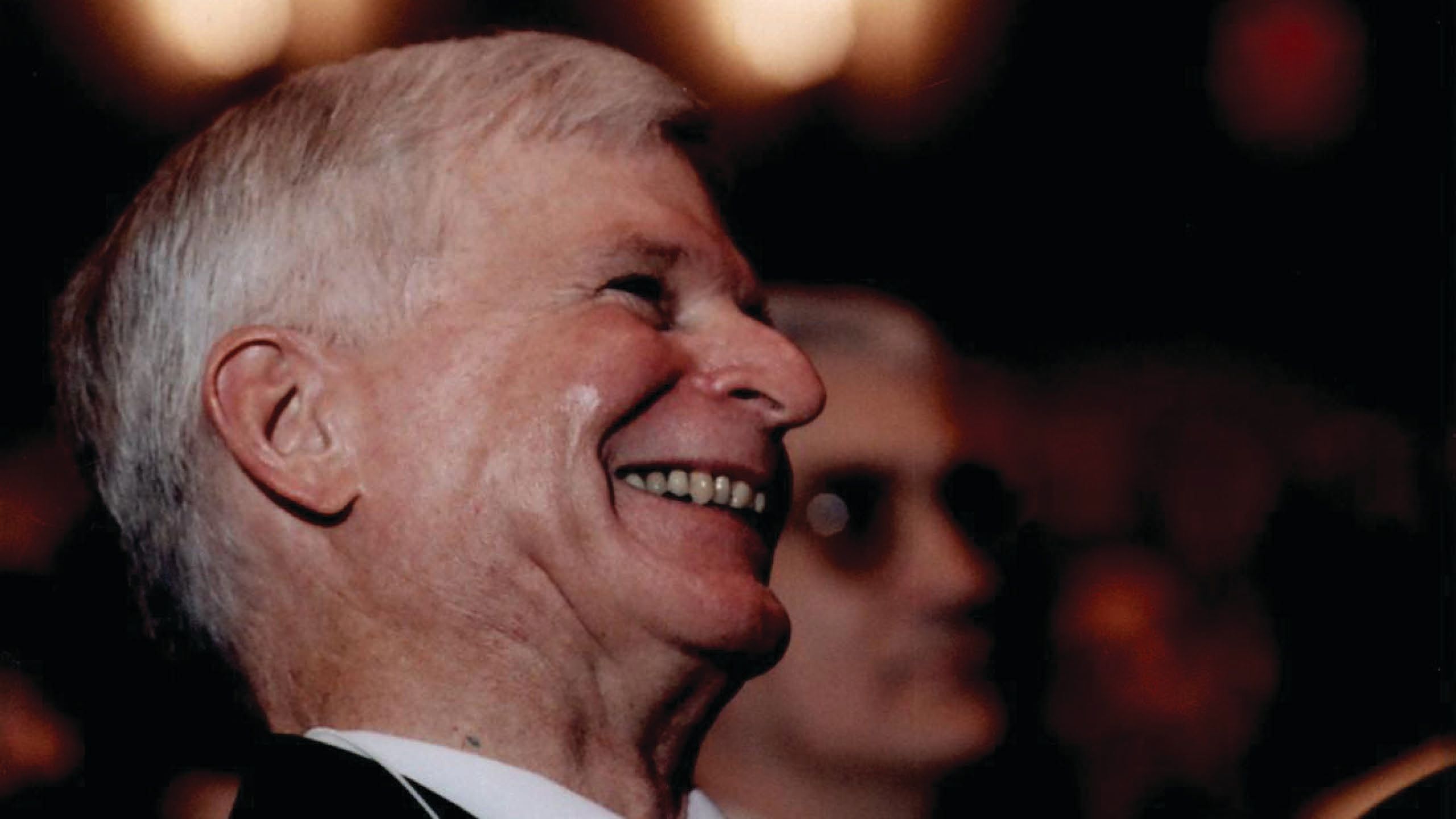 Profile view of Dean Butler with a large smile on his face.