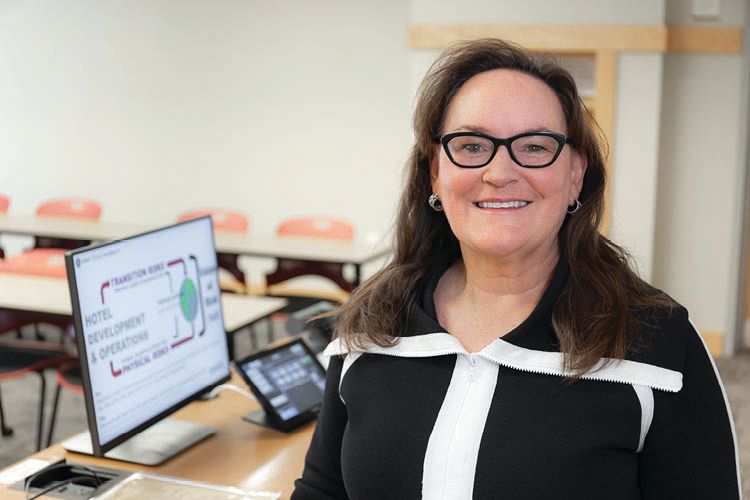 Jeanne Varney ’85 smiles in a classroom.