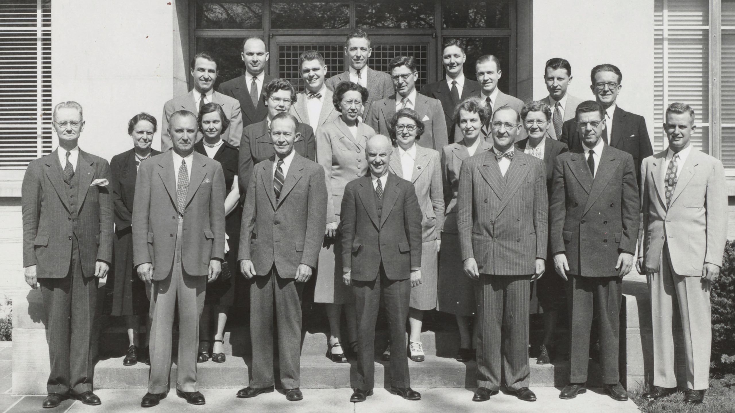 Dean Meek and his faculty in 1952 pose in front of a building. 